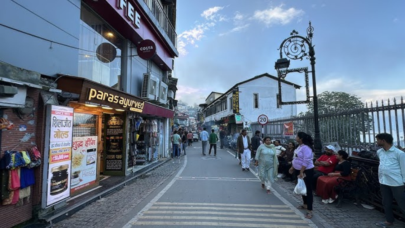 Mall Road in Mussoorie with shops, cafes, and hill views