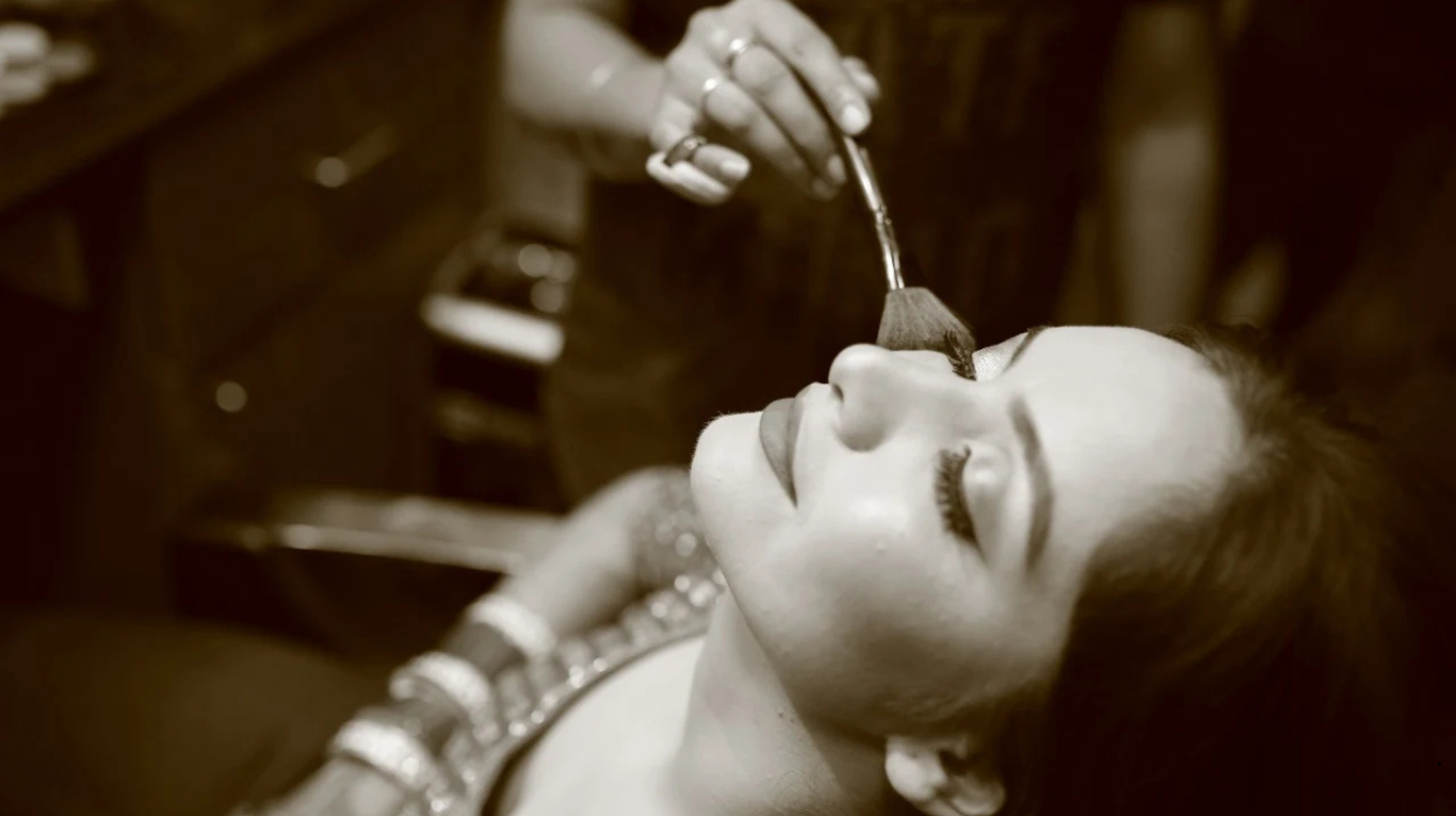 Close-up of makeup artist blending foundation for a natural finish